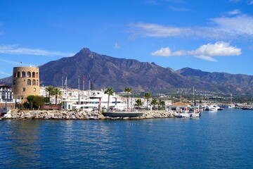 famous habor Puerto Banús with luxury yachts and the Pico de la Concha mountain in beautiful evening light, Marbella, Malaga, Costa del Sol, Spain