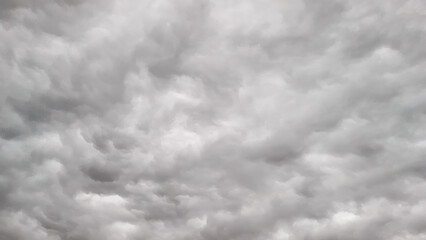 Aerial perspective of a turbulent sky filled with storm clouds, taken by drone