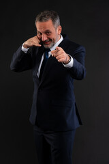 Businessman pointing and making call me gesture.