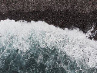 Aerial View of Waves Crashing on Rocky Shoreline