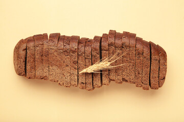 Fresh sliced rye bread loaf on beige background