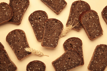 Fresh sliced rye bread loaf on beige background
