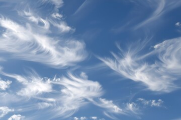 Wispy cirrus clouds creating beautiful patterns against a vibrant blue sky, offering a serene and picturesque view