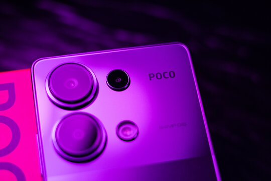 KYIV, UKRAINE - April 15, 2025 :  Modern smartphone Xiaomi POCO in purple colour on black background.
