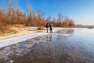 Frozen Lakeside Landscape with People Enjoying Winter Scenery on a Beautiful Day Trip Adventure