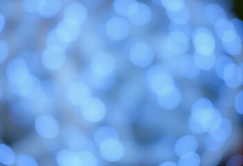 Abstract blurred background with blue and white bokeh.