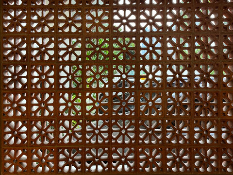 Floral pattern of clay honed breeze block or roster. Breeze block is commonly used for wind screen in architecture walls. Ethnic floral pattern of breeze blocks
