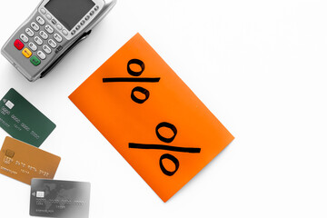 Sales with discount percentage sing on white background. Online shopping. Top view of a POS payment terminal and credit cards