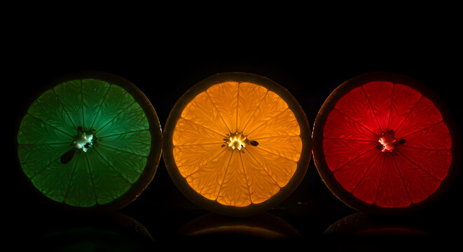 Colorful Citrus Symphony Glowing Fruit Slices On Dark Backdrop