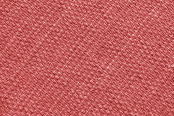 Fototapeta premium Texture of red natural fabric with large diagonal weaving. Surface, structure of upholstery or carpet material, cloth background close up.
