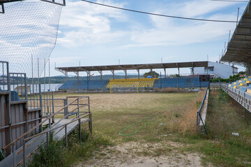 Abandoned stands of a football pitch on the beach