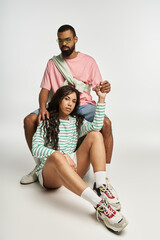 Stylish couple exuding love and confidence in a contemporary studio setting