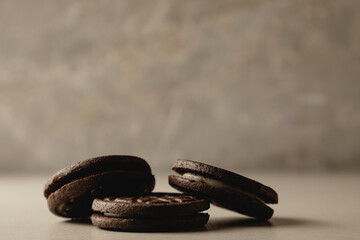 Delightful chocolate cookies resting on a smooth surface in soft lighting