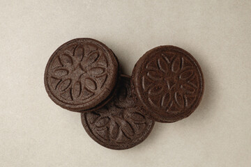 Delicious chocolate cookies arranged in an artistic display on a beige surface