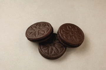 Delicious chocolate sandwich cookies stacked temptingly on a light background