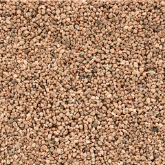 Fine gravel or coarse sand in various shades of brown texture background