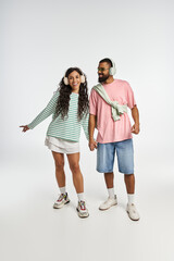 Stylish couple enjoying each others company with joy in a bright studio setting