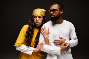 Stylish couple embracing love and individuality in a creative modern setting