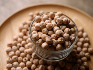 Raw Chickpeas on a rustic wooden table. Dry chickpea background close up. Chickpea legumes seed background.