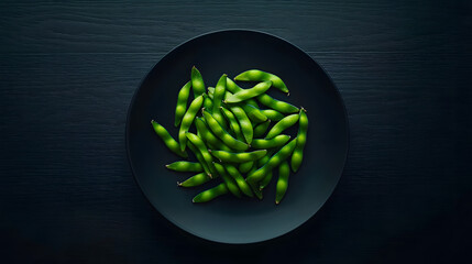 A plate of green beans is on a black table