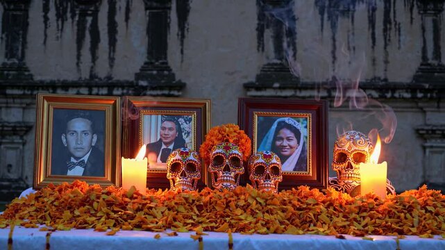 Cempasuchil petals, decorated skulls, lit candles and framed portraits of family members create a vibrant ofrenda, honoring loved ones during dia de muertos