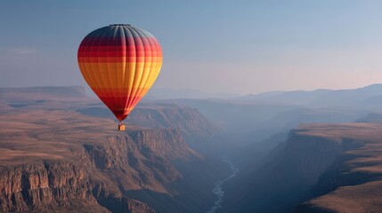 Obraz premium Hot air ballooning above desert canyon at dawn. Scenic travel adventure.