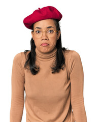Young Filipina with Parisian look shrugs shoulders and open eyes confused.