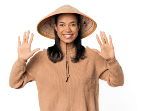 Young Filipina with Vietnamese hat showing number ten with hands.