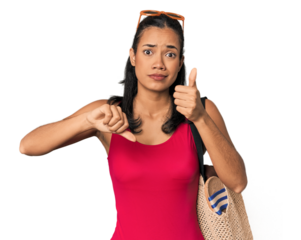 Young Filipina with beach bag showing thumbs up and thumbs down, difficult choose concept