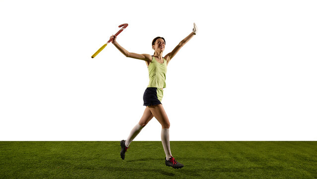 Athlete jumping with arms up, celebrating success on green grass field against white studio background. Emotional high of winning game. Concept of sport events, competition, championship. - Powered by Adobe