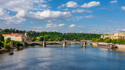 View of Vltava River in the center of Prague, with Manes Bridge and cruise ships