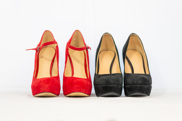 black and red pumps next to each other with a white background