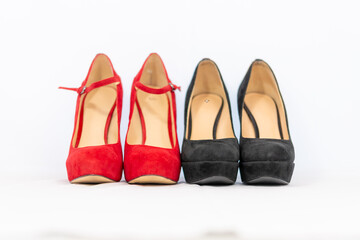 black and red pumps next to each other with a white background