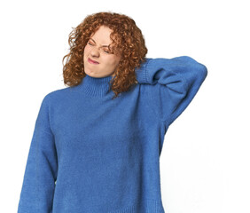 Young Caucasian redhead woman suffering neck pain due to sedentary lifestyle.