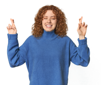Young Caucasian redhead woman crossing fingers for having luck - Powered by Adobe