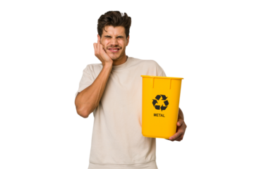 Young caucasian man holding a metal trash for recycle Young caucasian man holding recycling bins isolated on white background covering ears with hands.