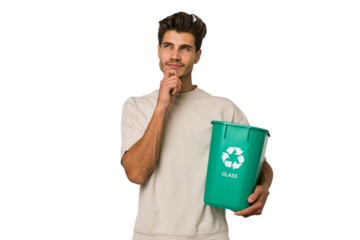Young caucasian man holding a glass trash isolated looking sideways with doubtful and skeptical expression.