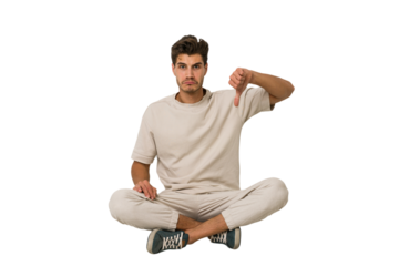 Young caucasian man sitting on the floor isolated on white background showing a dislike gesture, thumbs down. Disagreement concept.