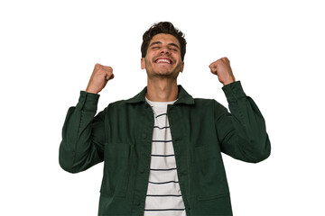 Young handsome caucasian man isolated on white background celebrating a victory, passion and...