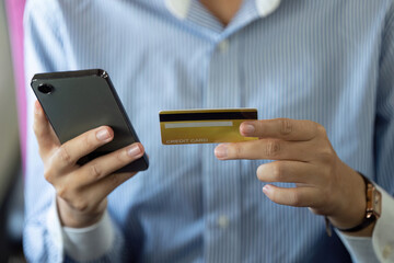 Business travel: Woman using smartphone and credit card to manage expenses