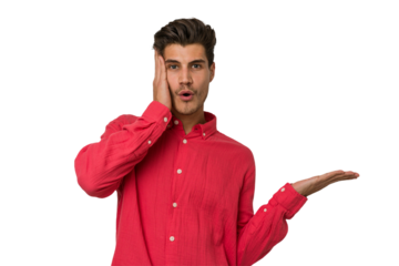 Young handsome caucasian man isolated on white background impressed holding copy space on palm.