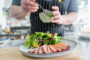 The chef serves roast duck. 