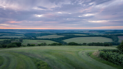 Serene sunset over rolling hills breathtaking countryside view idyllic pastoral scene