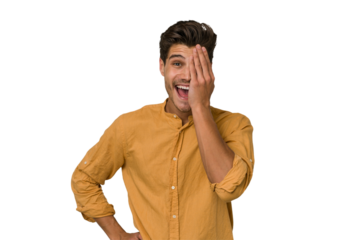 Young handsome caucasian man isolated on white background having fun covering half of face with palm.