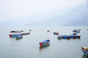 Many traditional boats are docking at Phewa Lake or Phewa Tal in the morning.