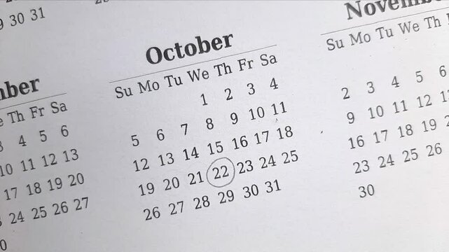 marking  22 October date on the calendar	
