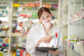 woman pharmacist checks and arranges medicines on pharmacy shelves, emphasizing precision and responsibility in healthcare services. The scene highlights the daily operations in a modern pharmacy.