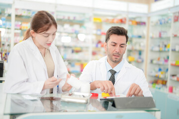 team man and woman pharmacist inspects a medication bottle, ensuring accuracy in prescription...