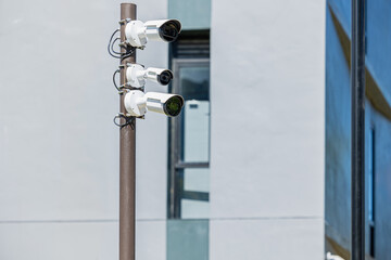 CCTV multi angle cameras security. Surveillance Video Camera on Pole at building background.