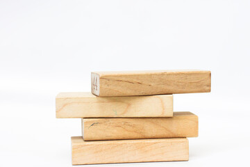 A pile of four wooden blocks on the soft white background.